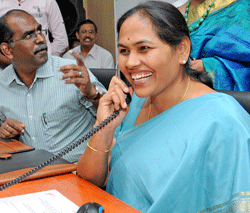 Energy Minister Shobha Karandlaje receiving an emergency call after inaugurating the HT Cell (For Women) at BESCOM Corporate office, in Bangalore on Wednesday. (From left) FKCCI President K Shiva Shanmugam and BESCOM MD Manivannan are also seen. DH photo