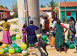 Water wait: Women and children waiting patiently to collect water. dh photo