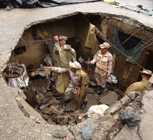 Indo-Tibetan Border Police (ITBP) personnel search for flood victims in a damaged house in Uttarkashi in the Himalayan state of Uttarakhand in this handout photo released on June 26, 2013. Rotting corpses contaminating water sources and poor sanitation amid devastating floods in northern India could lead to a serious outbreak of diseases such as cholera and dysentery, aid groups warned on Wednesday. The floods, triggered by heavy monsoon rains more than 10 days ago, have killed at least 822 people in Uttarakhand and forced tens of thousands from their homes. Officials say the death toll may cross 1,000 and thousands are still reported missing. REUTERS