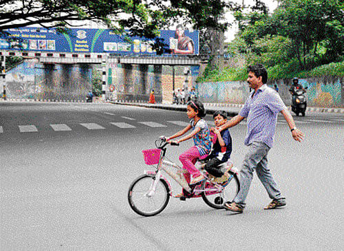 field day: It was a good day to teach children cycling as most vehicles remained off the road due to the Bangalore bandh call given by some Kannada organisations on Thursday. DH photo