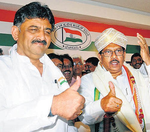 Minister D K Shivakumar  and KPCC president G Parameshwara show thumbs up  in celebration of the Congress's victory in the bypolls.  DH photo