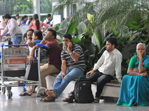 Passengers waiting at the Kempegowda international airport, flights are rescheduled during the Karnataka bandh in Bengaluru on Saturday.  DH photo