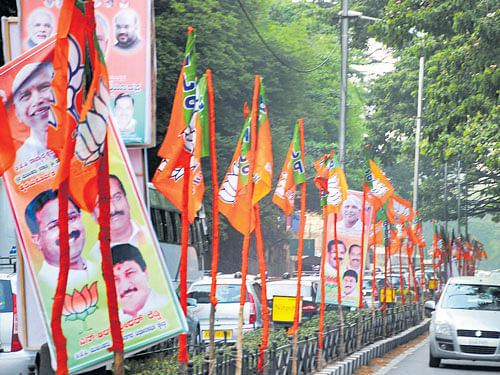 Flex boards and BJP flags deck Ballari Road on the eve of the first public meeting to be held to mark B S Yeddyurappa's  appointment as state BJP chief. DH photo