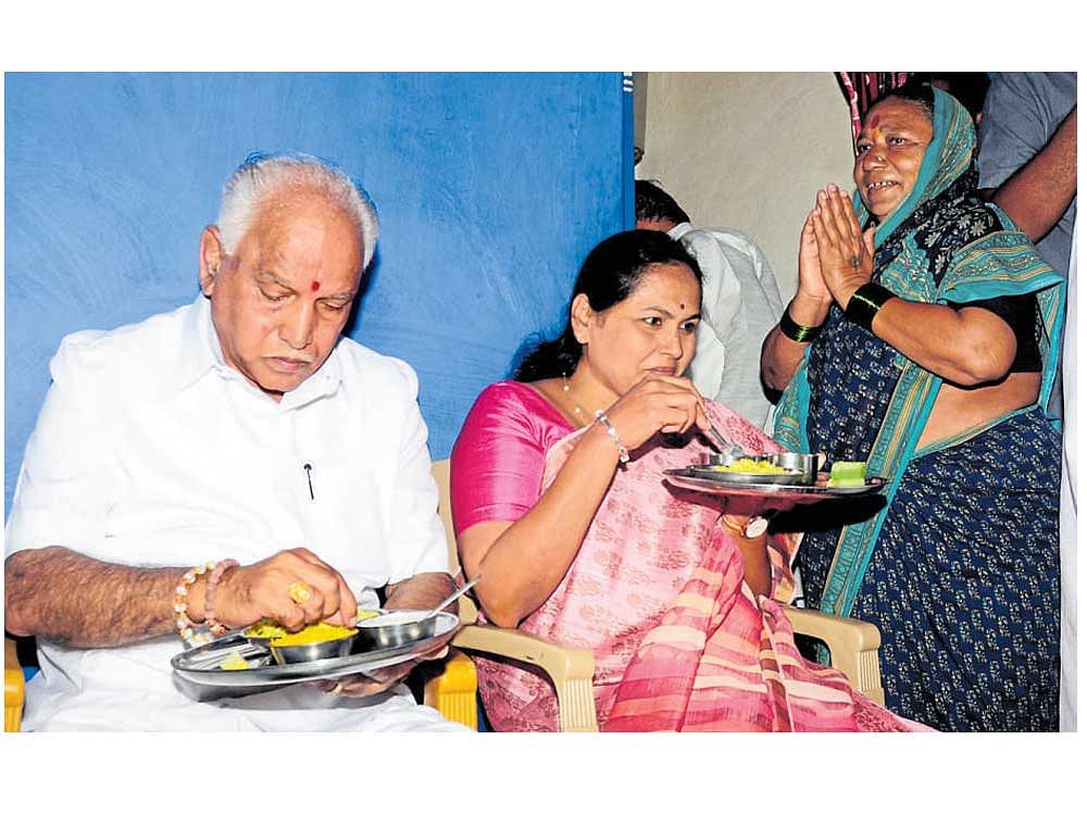 BJP&#8200;state president B&#8200;S&#8200;Yeddyurappa and Lok Sabha member Shobha Karandlaje eat breakfast at the house of a Dalit in Bagalkot on Monday. DH&#8200;photo