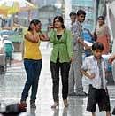 Summer Shower: Shoppers on MG Road enjoy the showers on Tuesday evening. DH Photo