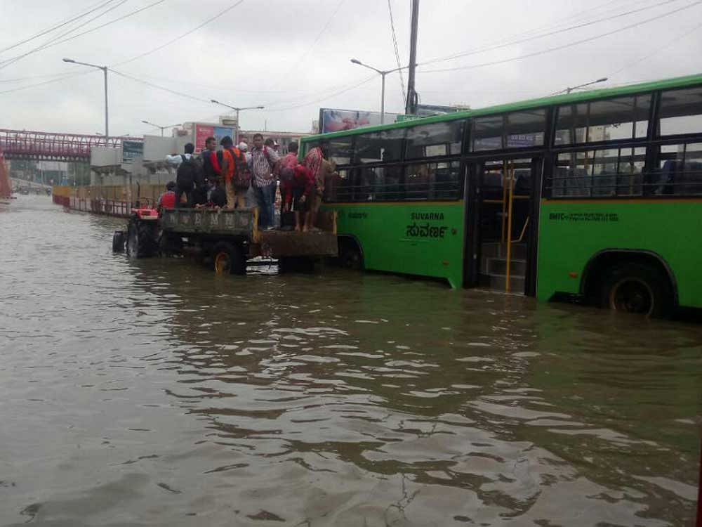 A BMTC bus broke down on the waterlogged outer ring road near Ecospace and more than 20 passengers were rescued by BBMP personnel. DH Photo
