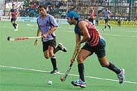 IOCL player Prabjoth Singh in full control of the ball at the State-level Super Division Hockey League championship match in Madikeri on Friday.  DH Photo