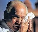 Chief Minister B S Yeddyurappa wipes his tears during his speech at the  inauguration of Sadhana Samaavesha in Bangalore on Friday. DH photo