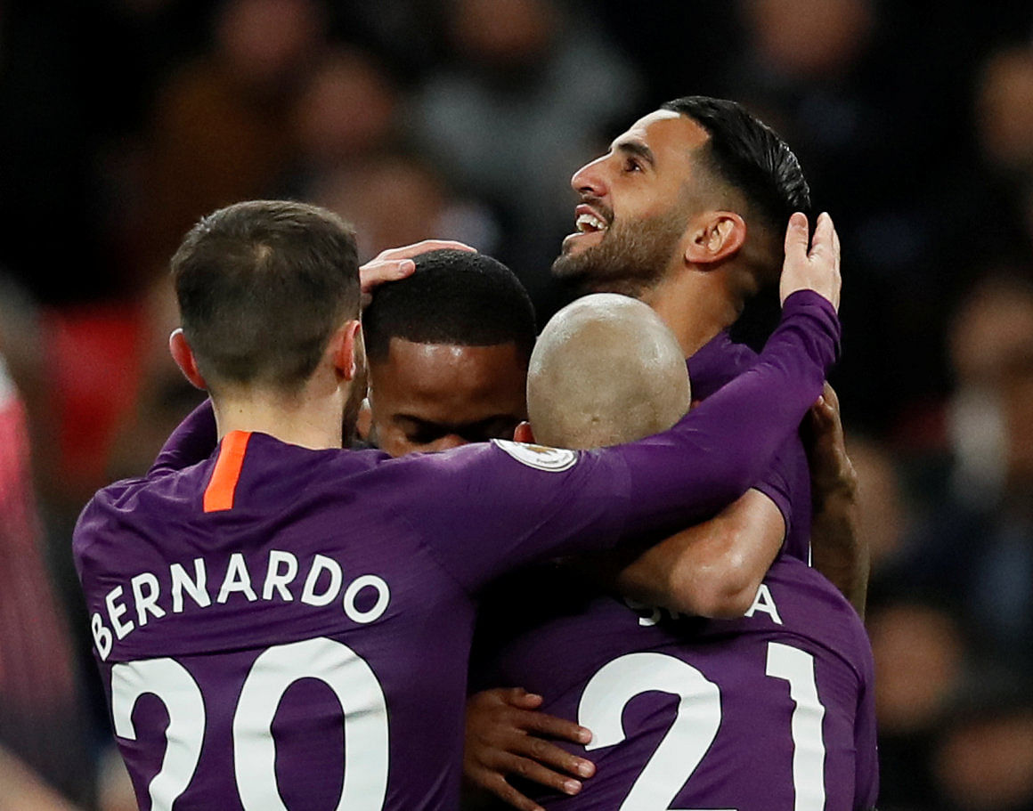 Manchester City's Riyad Mahrez (right) celebrates with team-mates after scoring against Tottenham Hotspur on Monday night. REUTERS