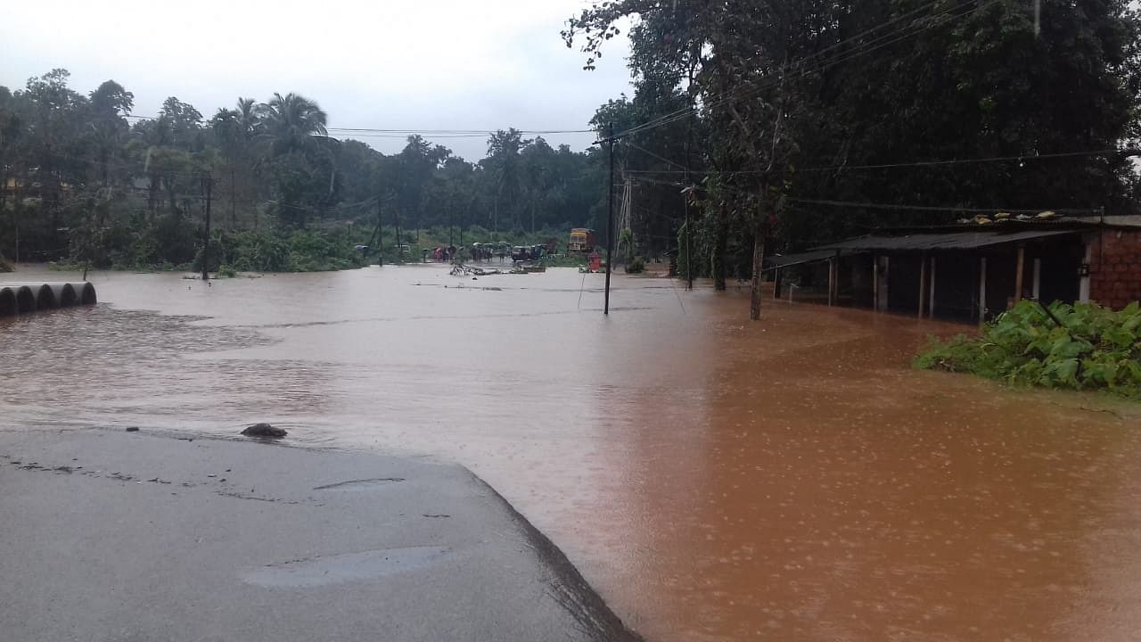 Water from Gundya river breaches National Highway-75 that connects Bengaluru and Mangaluru at Udane. (DH Photo) 