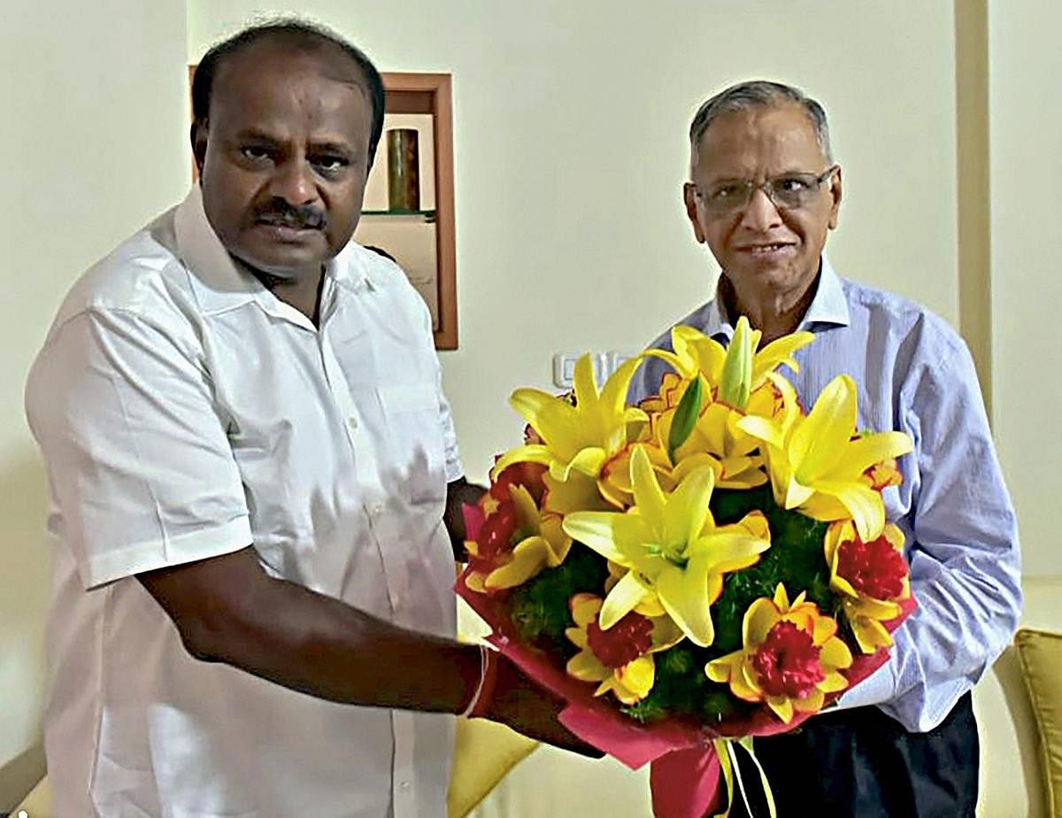 Karnataka Chief Minister H D Kumaraswamy (L) greets Infosys co-founder N R Narayana Murthy in Bengaluru on Friday. PTI
