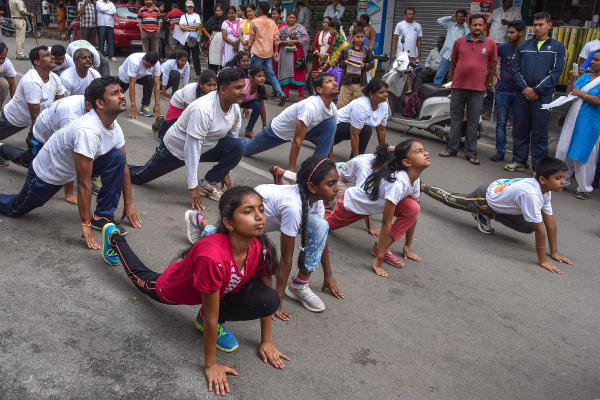 Yoga students hold a yoga demonstration to create awareness ahead of the International Yoga Day, in front of Ganesha Temple in Lakasandra on Sunday. Photo/S K Dinesh