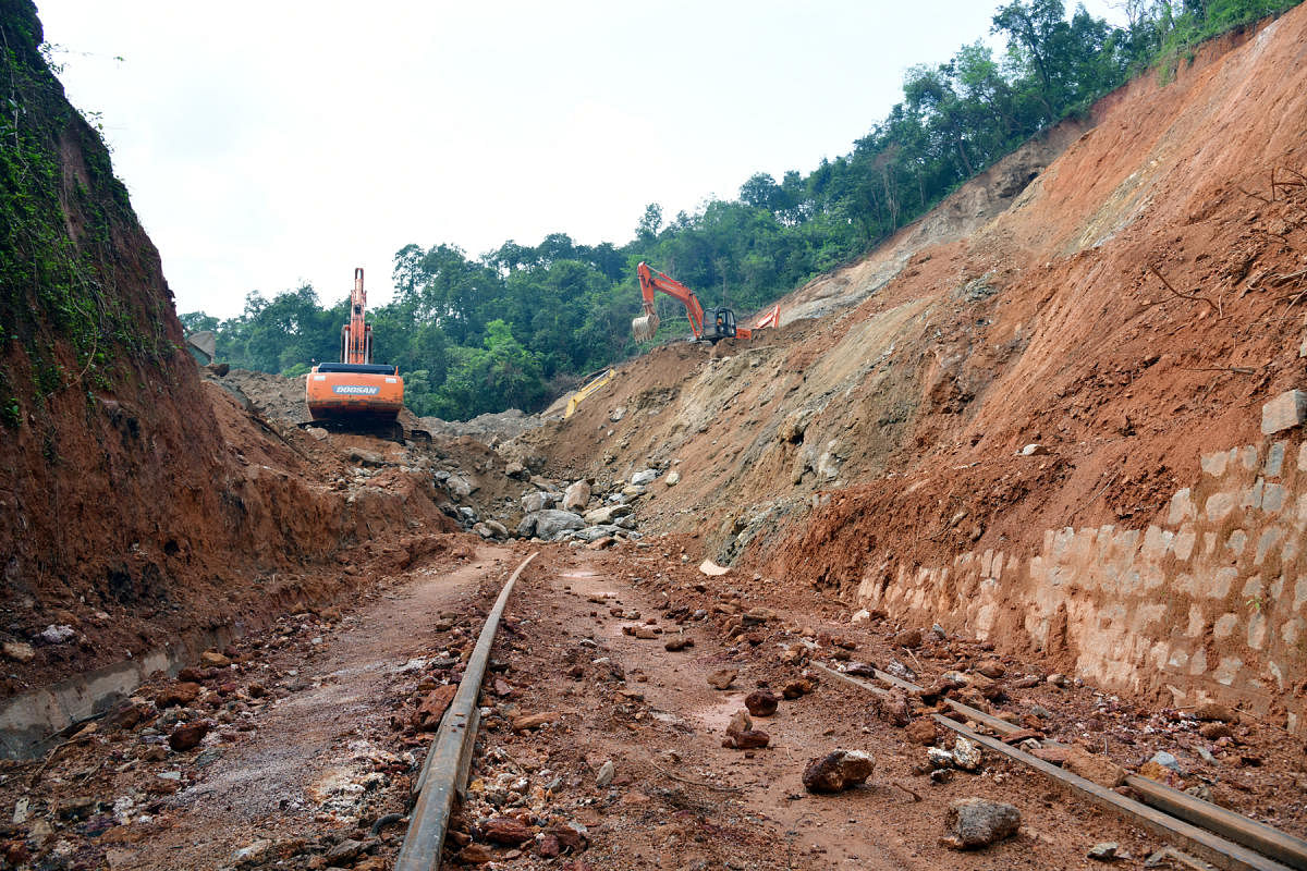Mounds of soil and boulders being removed from railway tracks on Sakleshpur-Subrahmanya route. DH PHOTO