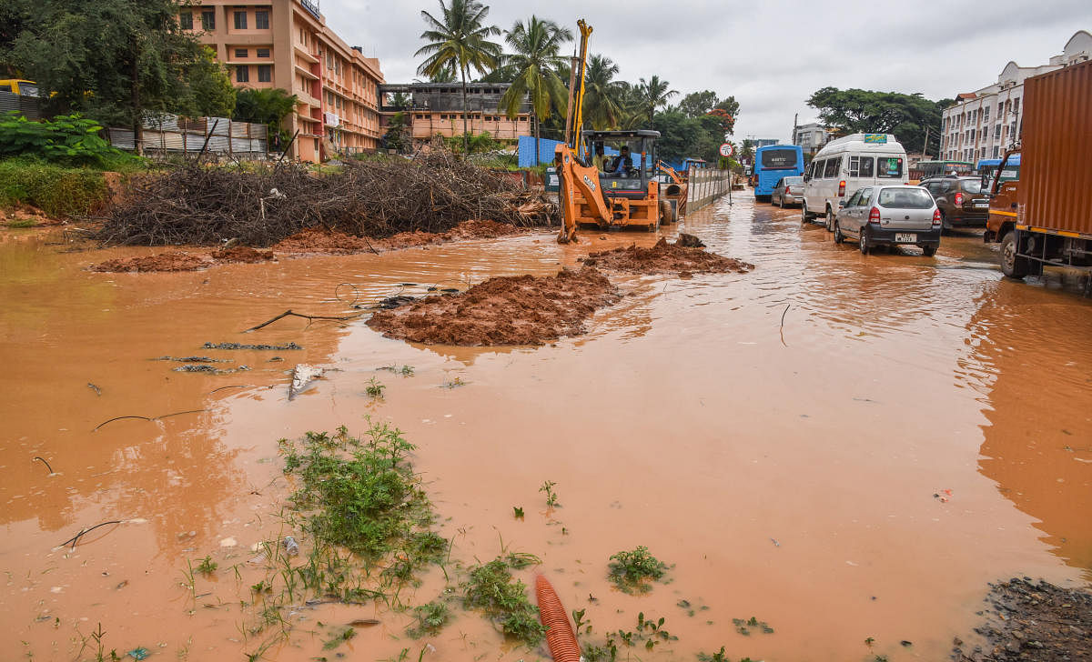 Rainwater floods a road near Meenakshi Temple in Kalena Agrahara, Bannerghatta Road, on Monday. DH Photo/S K Dinesh