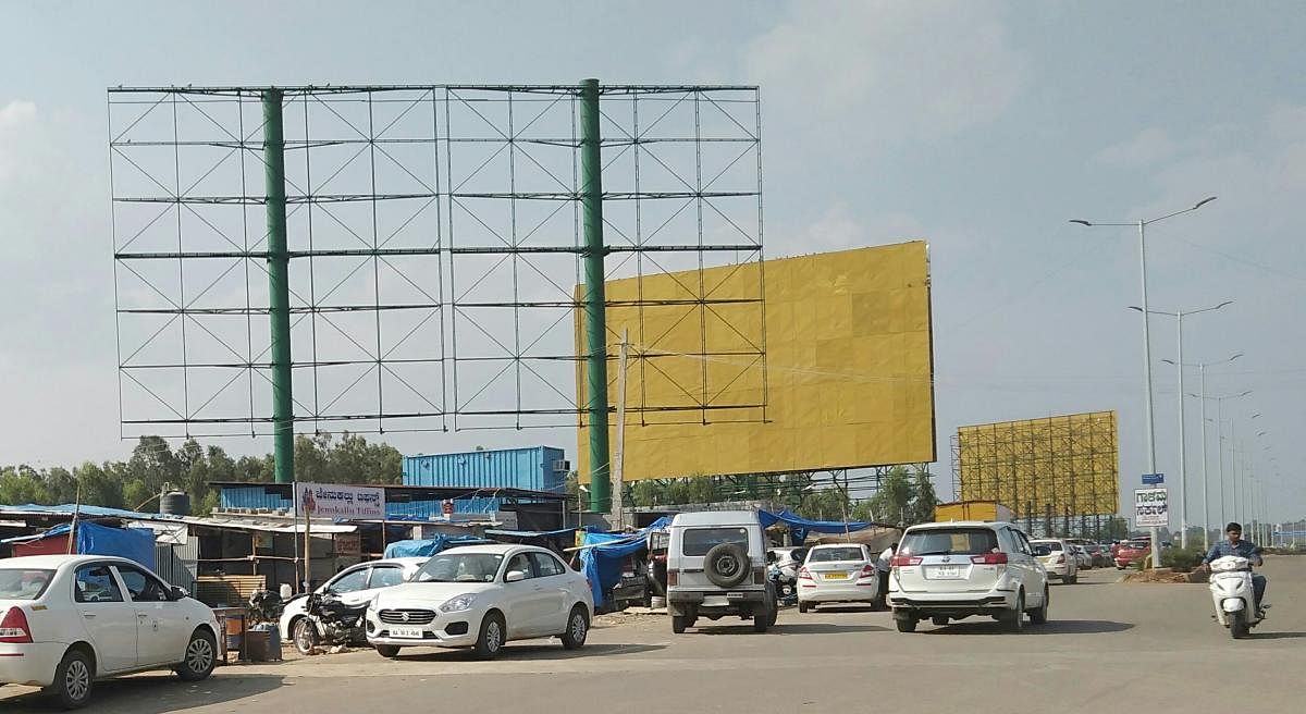 Illegal Hoardings: Gone missing from city but popped up around KIA. DH Photo