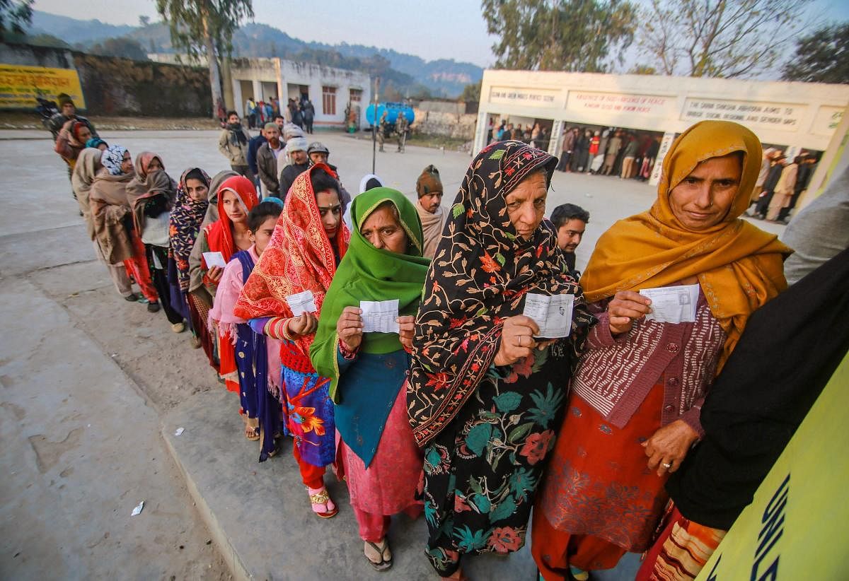 Voters stand in a queue to cast their votes in the 8th phase of Panchayat elections, at Bajalta village in Jammu, on December 8, 2018. PTI
