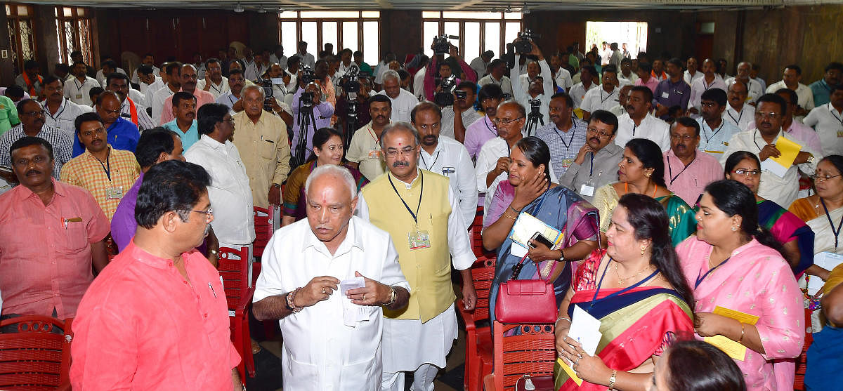 State BJP president B S Yeddyurappa arrives at the workshop for heads of 'Shakti Kendras,' held in Bengaluru on Friday. MLA R Ashoka, party election co-in-charge Kiran Maheshwari and state general secretary Arvind Limbavali are seen. DH Photo
