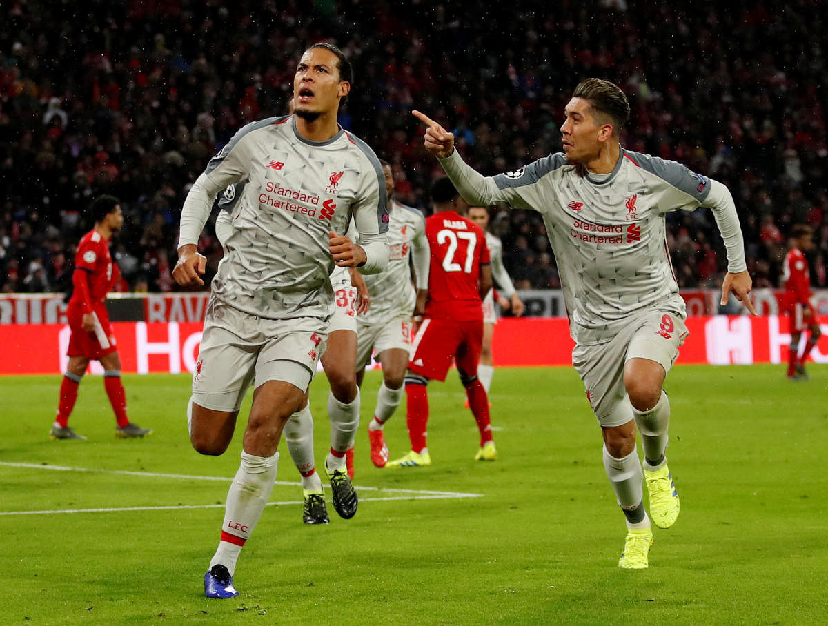 Liverpool's Virgil van Dijk (right) celebrates with team-mate Roberto Firmino after scoring against Bayern Munich in the last-16 second leg in Munich on Wednesday. Reuters
