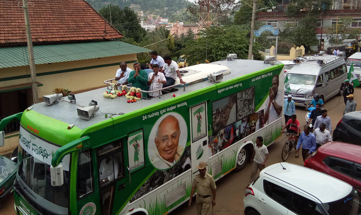 JD(S) State President H D Kumaraswamy and JD (S) candidate M Sanketh Poovaiah take part in a roadshow in Virajpet.