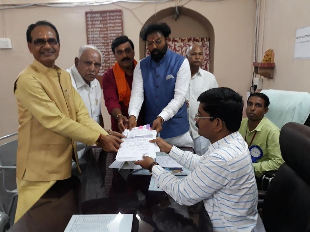 The BJP MP B Sriramulu files his nomination papers from Molakalmuru (ST) constituency in Chitradurga district on Saturday. Madhya Pradesh Chief Minister Shivraj Singh Chouhan, BJP state president B S Yeddyurappa, former minister and mining baron G Janardh