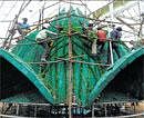 AWORKOFART:Work is on at the floral representation of the Lotus Temple, which will be on display at the annual flower showat Lalbagh, onWednesday. DH PHOTO
