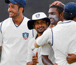 WELL DONE, MATE: Karnataka's Abhimanyu Mithun (secon d from right) celebrates with team-mates after dismissing  Vidarbha's Amol Ubarhande during their Ranji Trophy match in Mysore on Tuesday. DH PHOTO/ PRASHANTH H G
