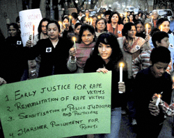 People holding a candle light march demanding justice for the gang rape victim, in Noida on Monday. PTI