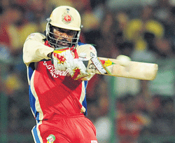 Take that! Royal Challengers Bangalores Chris Gayle launches into a shot during his teams win over Rajasthan Royals. DH PHOTO