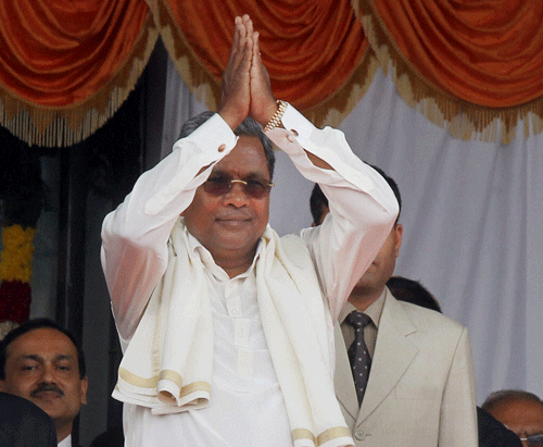 Siddaramaiah greeting the crowd after he was sworn-in as the new Chief Minister of Karnataka at Kanteerava Stadium in Bengaluru on Monday. PTI Photo