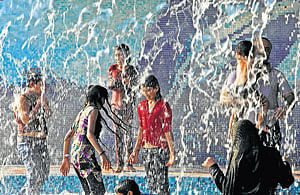 Children cool themselves at a water park on a hot summer afternoon in Hyderabad on Friday. AP
