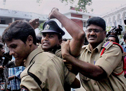 An on duty constable is arrested after he shouted slogans in support of separate Telangana State in the Assembly in Hyderabad on Thursday. PTI Photo