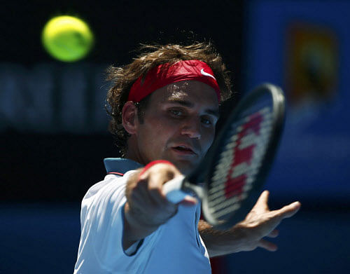 Roger Federer of Switzerland hits a return to James Duckworth of Australia during their men's singles match at the Australian Open 2014 tennis tournament in Melbourne January 14, 2014. REUTERS