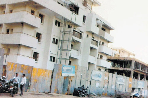 Controversial: A multi-storey apartment built allegedly by legislator Krishnappa's daughter and son-in-law on the land said to have been denotified illegally.