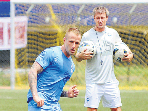 BFC coach Ashley Westwood is a keen observer as their new signing Joshua Walker goes through the paces at the Bangalore Football Stadium on Friday. DH photo