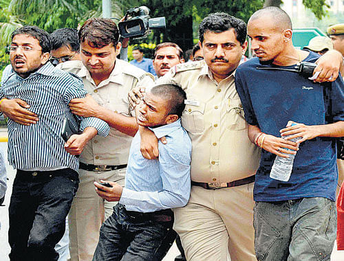 Police detain students during a protest demanding rollback of CSAT from Civil Services Examinations in New Delhi on  Friday. PTI photo