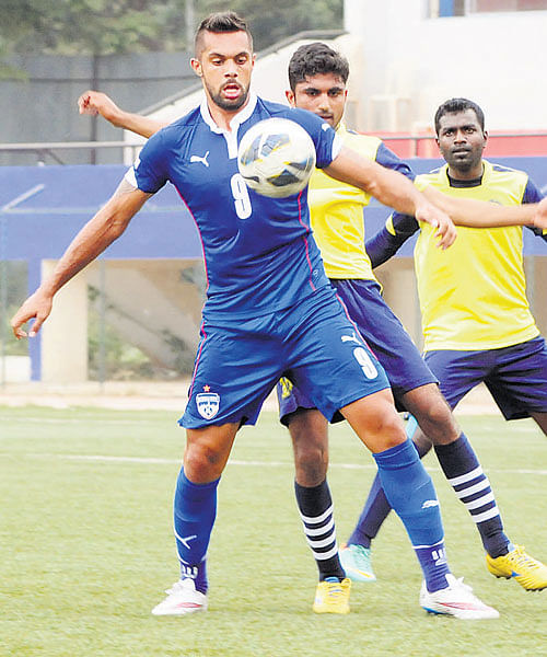 Bengaluru FC's Robin Singh shields the ball from RWF's S John and Nandakumar during their Puttaiah Memorial Cup encounter on Friday in Bengaluru. DH PHOTO