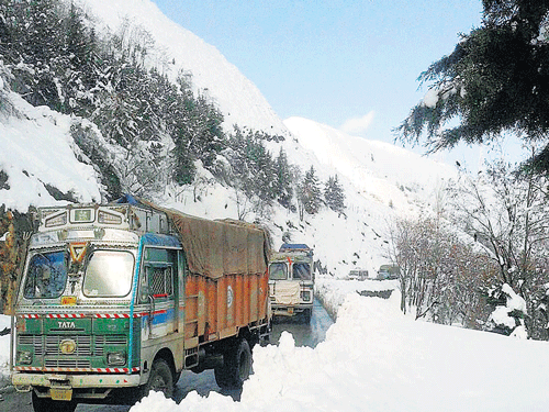 Goods trucks ply on Srinagar-Jammu National Highway after vehicular movement was thrown open  at Qazigund in South Kashmir on Wednesday. PTI