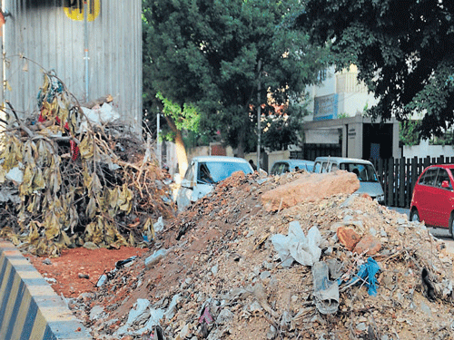 eyesore: Debris dumped below the Metro line on Vanivilas Road in Basavanagudi. DH photo