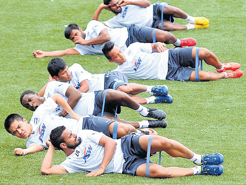 GEARING UP: Bengaluru FC players stretch during a training session at the Bangalore Football Stadium on Monday, ahead of the new season. DH PHOTO