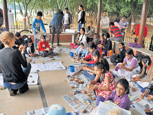 Children take part in the painting competition at the  Madiwala Kere Habba in the City on Saturday. DH photo