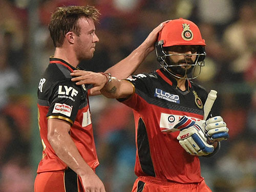 Royal Challengers Bangalore Virat Kohli returns the pavilion after his dismissal as AB De Villiers congratulate him during the IPL 2016 match against Sunrisers Hyderabad at Chinnaswamy stadium in Bengaluru on Tuesday. PTI Photo