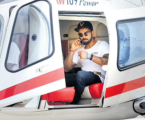 High flyer: Virat Kohli departs in a helicopter after a promotional event in Bengaluru on Thursday. DH photo