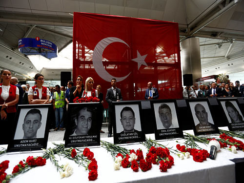 Airport employees attend a ceremony for their friends, who were killed in Tuesday's attack at the airport, at the international departure terminal of Ataturk airport in Istanbul, Turkey, June 30, 2016. REUTERS