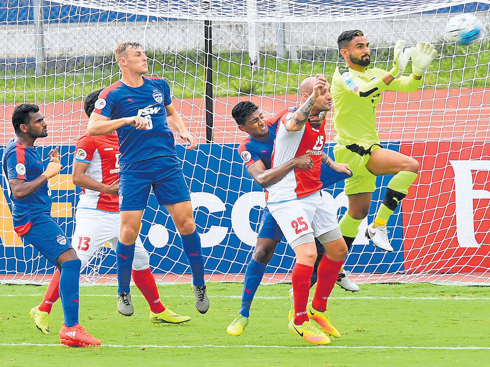 Comfortable Bengaluru FC goalkeeper Amrinder Singh (right) has an easy time collecting a cross during his side's match against Tampines Rovers. DH photo/ Srikanta Sharma R