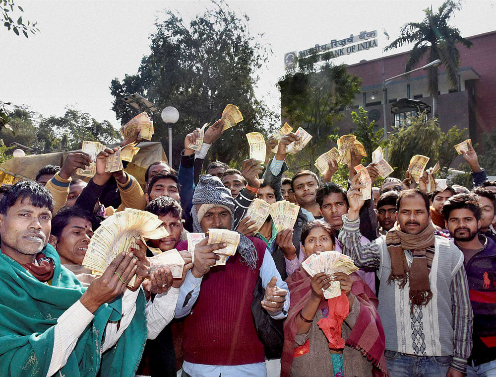 People showing demonetized notes outside the Reserve Bank of India (RBI) building as they could not exchange their old currency notes, in Patna, Bihar on Wednesday. PTI Photo