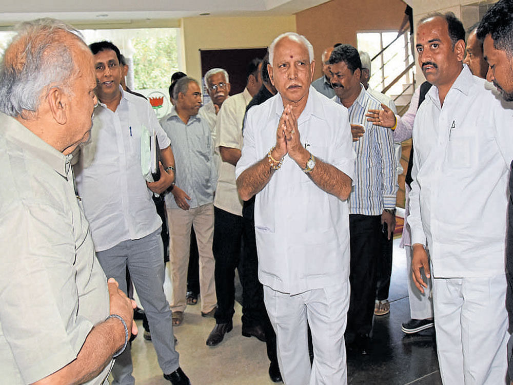 BJP state president B S Yeddyurappa arrives at the party  office in Bengaluru on Thursday to meet disgruntled  BJP leaders. dh Photo