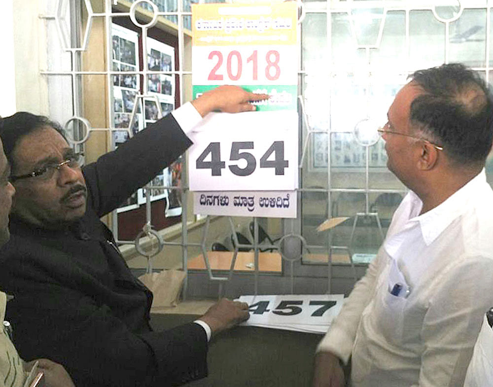 KPCC&#8200;president G Parameshwara and working president  Dinesh Gundu Rao unveil a countdown calendar for the  2018 Legislative Assembly elections, at the Congress office in Bengaluru on Thursday. DH Photo