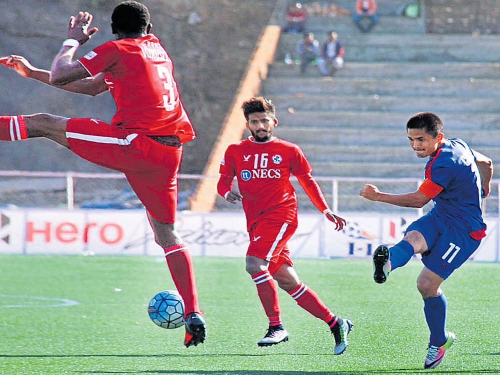 Too close BFC's Sunil Chhetri (right) attempts a shot past Aizawl's Eze Kingsley Obumneme (left) as Jayesh Rane looks on during their I-league tie on Wednesday. BFC&#8200;Media