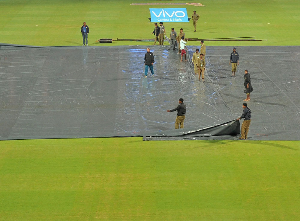 Pitch been covered by sheets as it rains during the IPL 10 match between Royal Challengers Bangalore and Sunrisers Hyderabad in Bengaluru on Tuesday. PTI Photo
