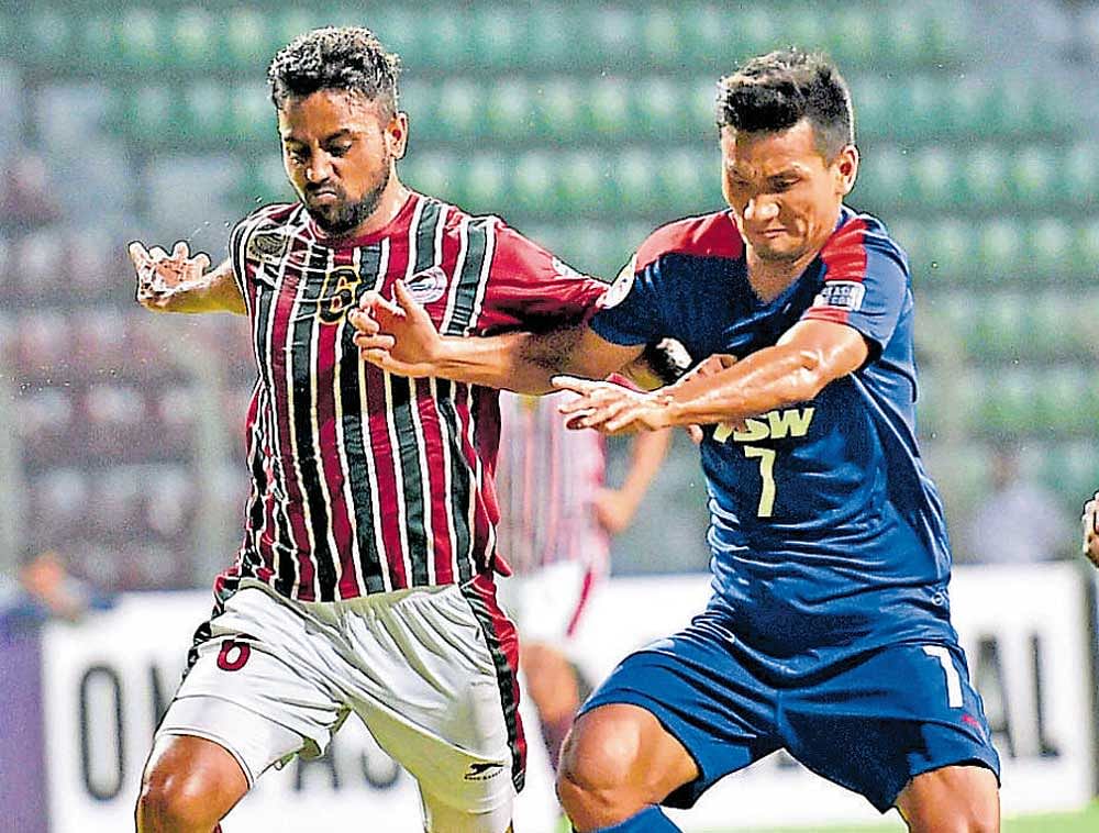 Mohun Bagan's Bikramjit Singh (left) vies for the ball with BFC's Seminlen Doungel on Wednesday. PTI